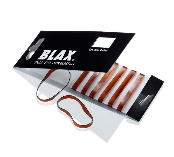 A partially open black BLAX package labeled BLAX Hair elastics - Brown (8 pcs) shows several brown, snag-free hair elastics inside, with two flexible plastic BLAX hair elastics lying outside.
