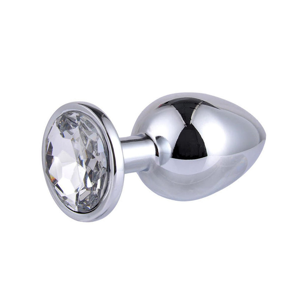 The Intimia Sparkling butt plug set features small, silver, stainless steel plugs with a rounded, tapered shape and a large clear gem at the base—ideal for stylish and pleasurable anal stimulation.
