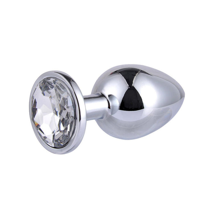 The Intimia Sparkling butt plug set features small, silver, stainless steel plugs with a rounded, tapered shape and a large clear gem at the base—ideal for stylish and pleasurable anal stimulation.